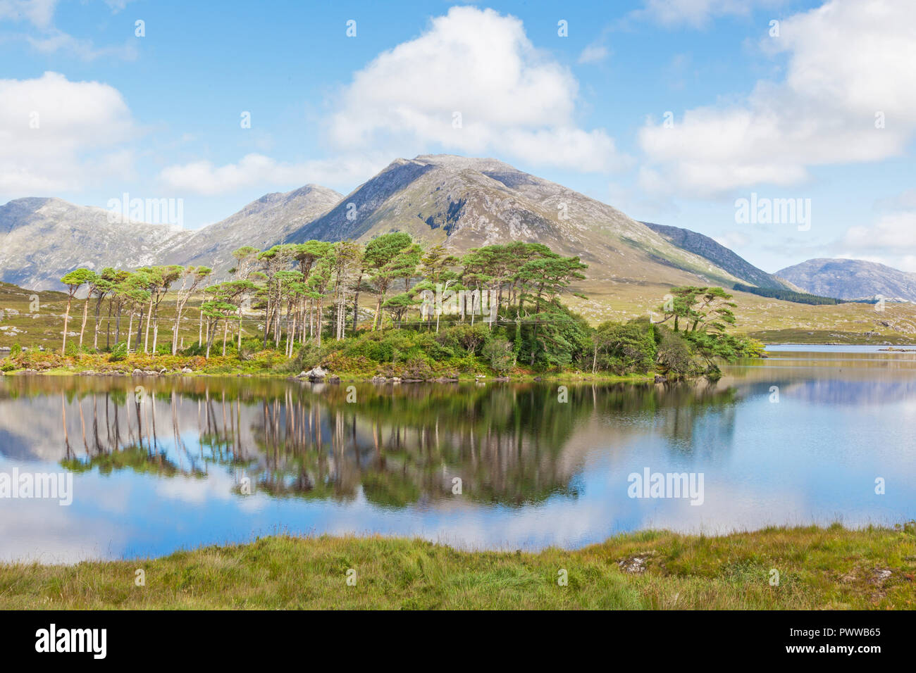 A mountainous landscape reflected in Derryclare Lough, in the Inagh