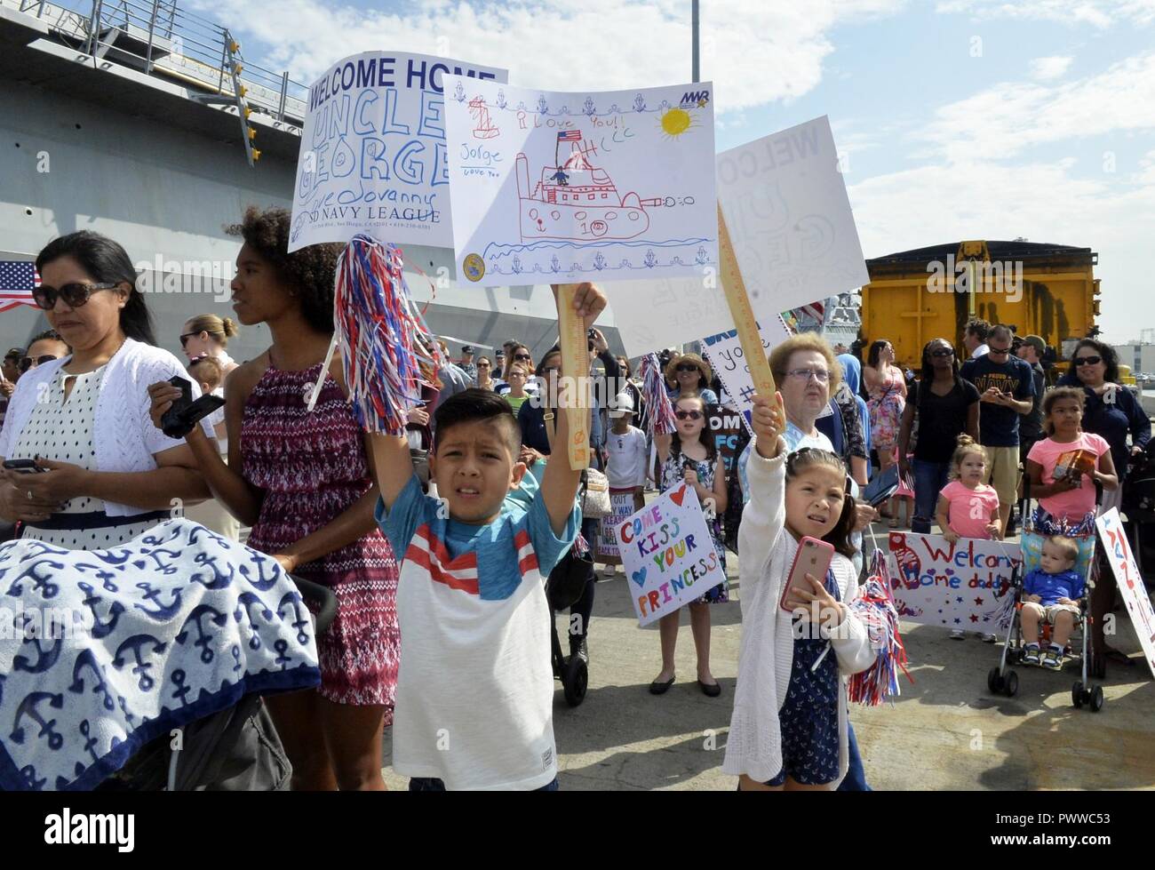 SAN DIEGO (July 5, 2017) Family members of Engineman 1st Class George Hernandez are waiting to greet him during the homecoming celebration of the littoral combat ship USS Gabrielle Giffords (LCS 10). Giffords is the newest Independence-variant littoral combat ship and one of seven littoral combat ships homeported in San Diego. ( Stock Photo