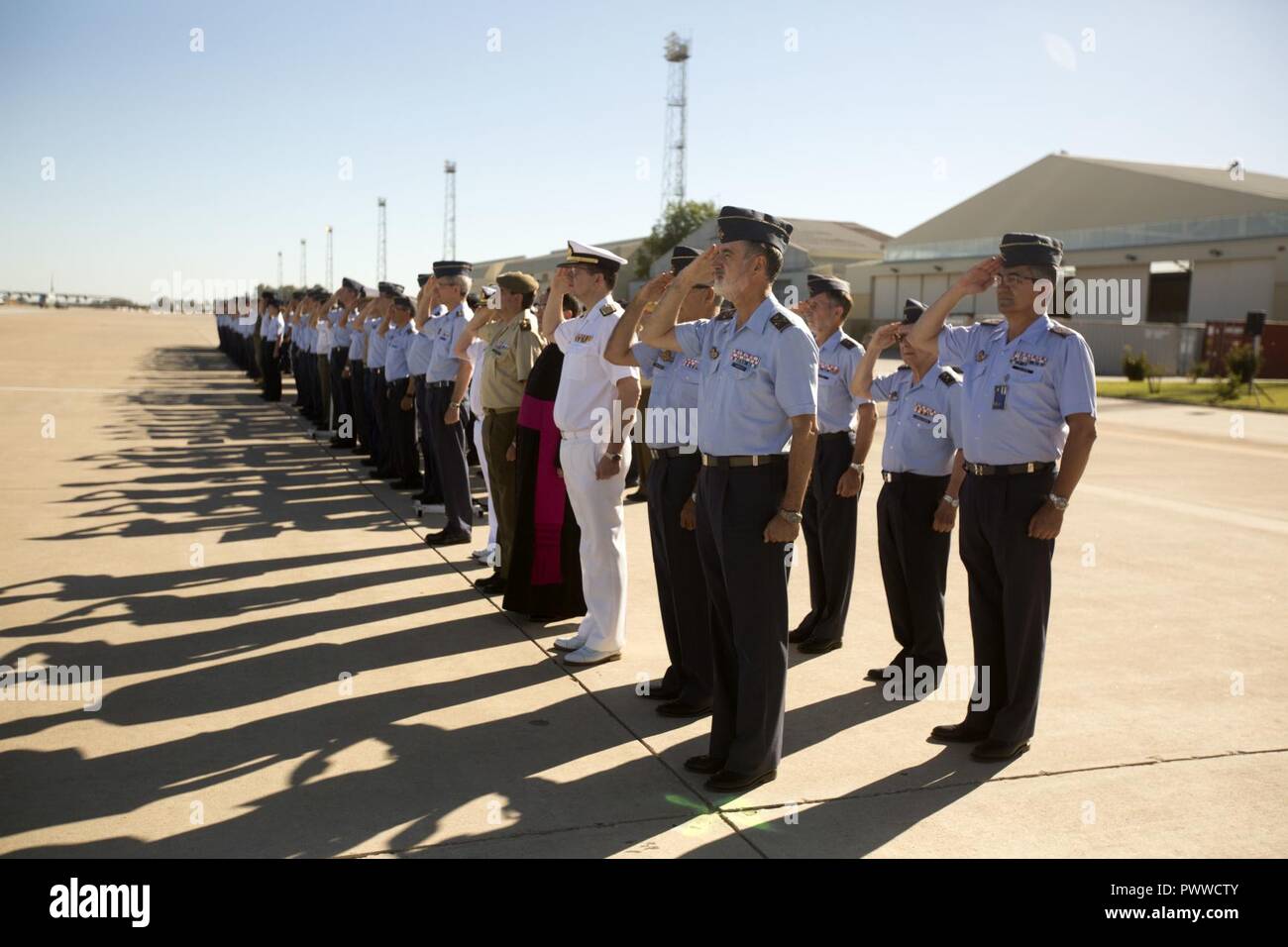 Members of the Spanish military and the U.S. Marine Corps and Air Force render salutes during the change of command ceremony between outgoing Spanish base commander, Col. Carlos Ysasi and oncoming base commander Col. Carlos Perez Martinez at Morón Air Base, Spain, July 3, 2017. Special Purpose Marine Air-Ground Task Force-Crisis Response-Africa deployed to conduct limited crisis response and theater security operations in Europe and North Africa. Stock Photo