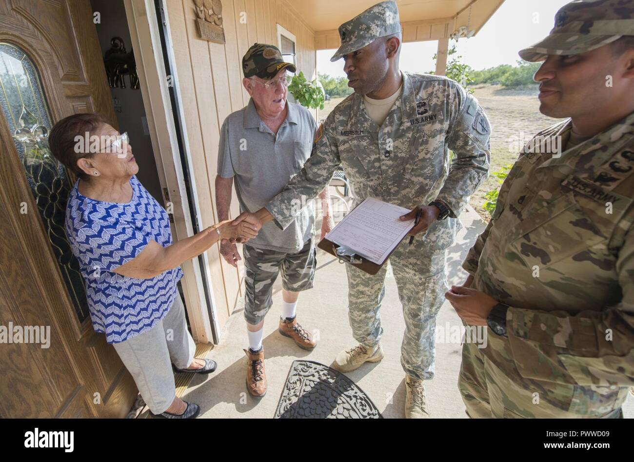 Sgt. 1st Class Rhody Merisier, middle right, and Staff Sgt. Aldo Blanco, both assigned to the 478th Civil Affairs Battalion based in Miami, conduct a survey with residents of a colonia currently without potable water near Laredo, Texas, June 23, 2017. Nearly 200 Reserve Soldiers are participating in an Innovative Readiness Training mission to improve infrastructures in colonias along the Texas-Mexico border. Stock Photo