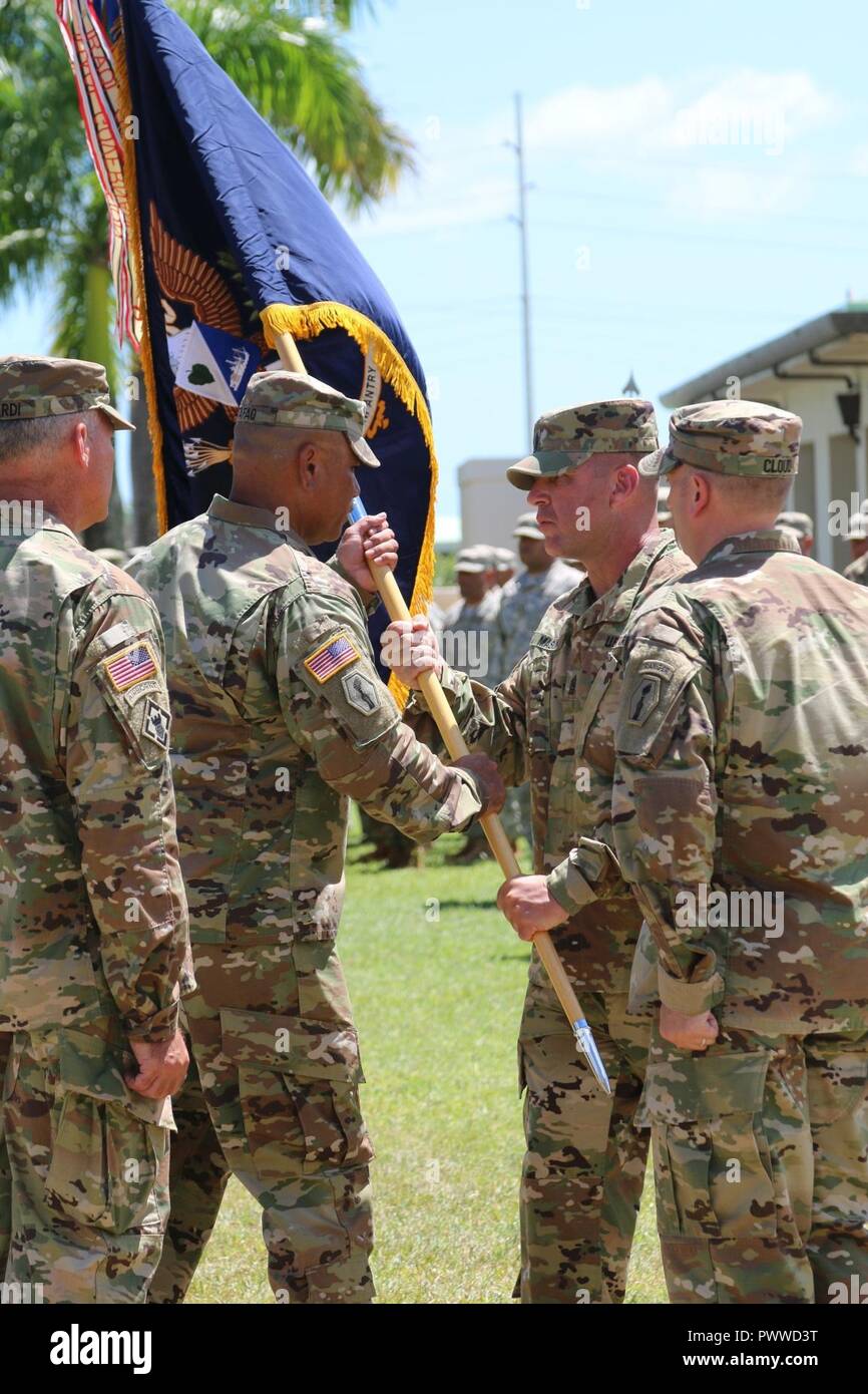 Lt. Col. Kenneth Tafao (center-left), outgoing commander of the 100th Inf. Bn., is passed the battalion colors during a change of command ceremony, June 22, at Fort Shafter Flats, U.S. Army Reserve Daniel K. Inouye Complex. Tafao relinquished command to Lt. Col. Matthew L. Cloud (right), a native of Illinois. Col. Joseph A. Ricciardi (left), commander, 303rd Maneuver Enhancement Brigade, and Command Sgt. Maj. Joshua T. Mason (center-right), command sergeant major, 100th Inf. Bn., witnessed the ceremony. Stock Photo