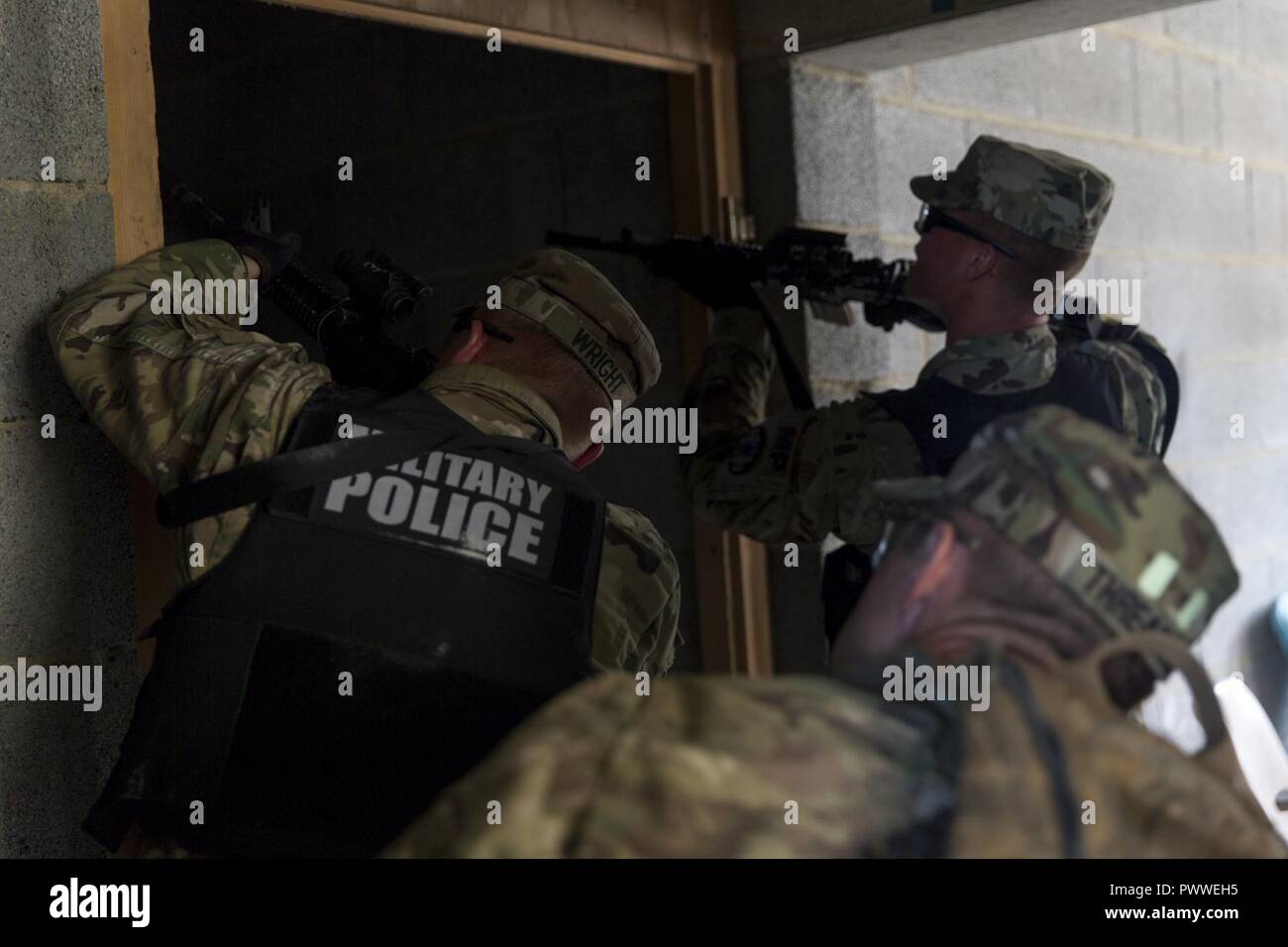 U.S. Soldiers of 93rd Military Police Battalion, 89th Military Police Brigade clear a building while conducting active shooter training during a Kosovo Force (KFOR) mission rehearsal exercise (MRE) at the Joint Multinational Readiness Center in Hohenfels, Germany, June 28, 2017. The KFOR MRE 23 is designed to prepare the 39th Infantry Brigade Combat Team for their deployment to Kosovo in support of civil authorities to maintain a safe and secure environment. KFOR MRE 23 hosts 900 soldiers from 10 nations. The exercise runs from June 19 through July 11 in Hohenfels, Germany. Stock Photo