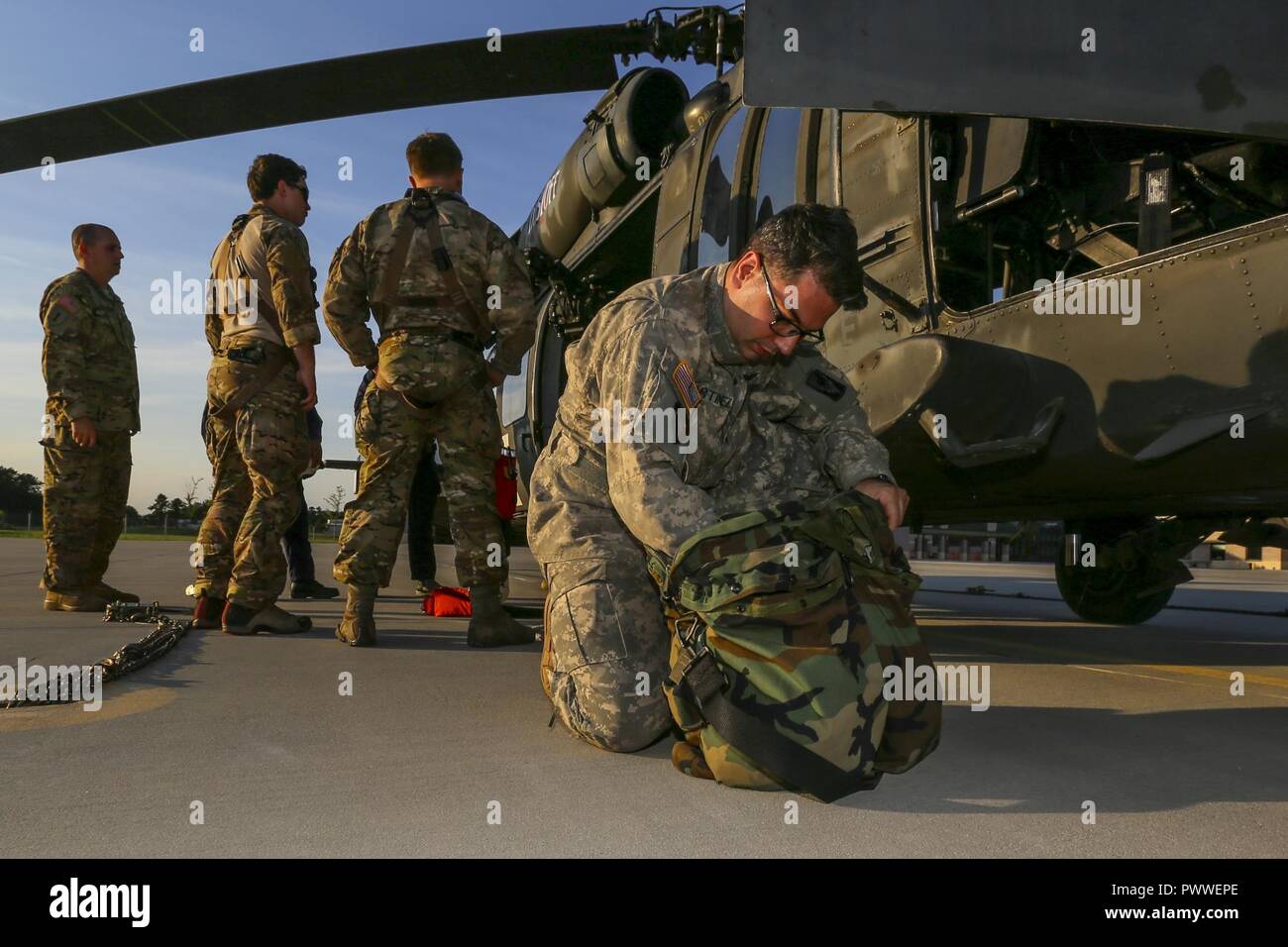 U.S. Army Chief Warrant Officer 2 Oscar Martinez, a Black Hawk pilot, prepares for a training mission at Joint Base McGuire-Dix-Lakehurst, N.J., June 28, 2017. Stock Photo