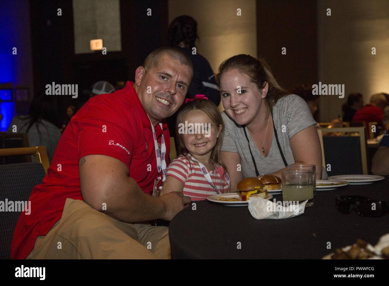 U.S. Marine Corps Cpl. Zachary Vinson and his family pose  during the 2017 DoD Warrior Games Family Dinner in Chicago June 30, 2017. Vinson, a native of Bowling Green, Va., is a member of Team Marine Corps. The family dinner was held for all service members and staff participating in the Warrior Games, an adaptive sports competition for wounded, ill and injured service members and veterans. Stock Photo