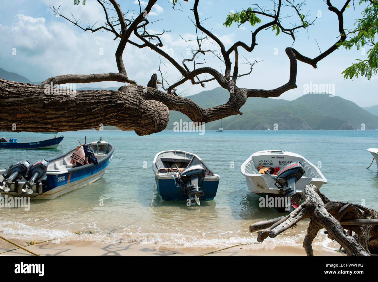 Motor boats parking on the beach. Playa Cristal, Tayrona Park, Colombia. Sep 2018 Stock Photo