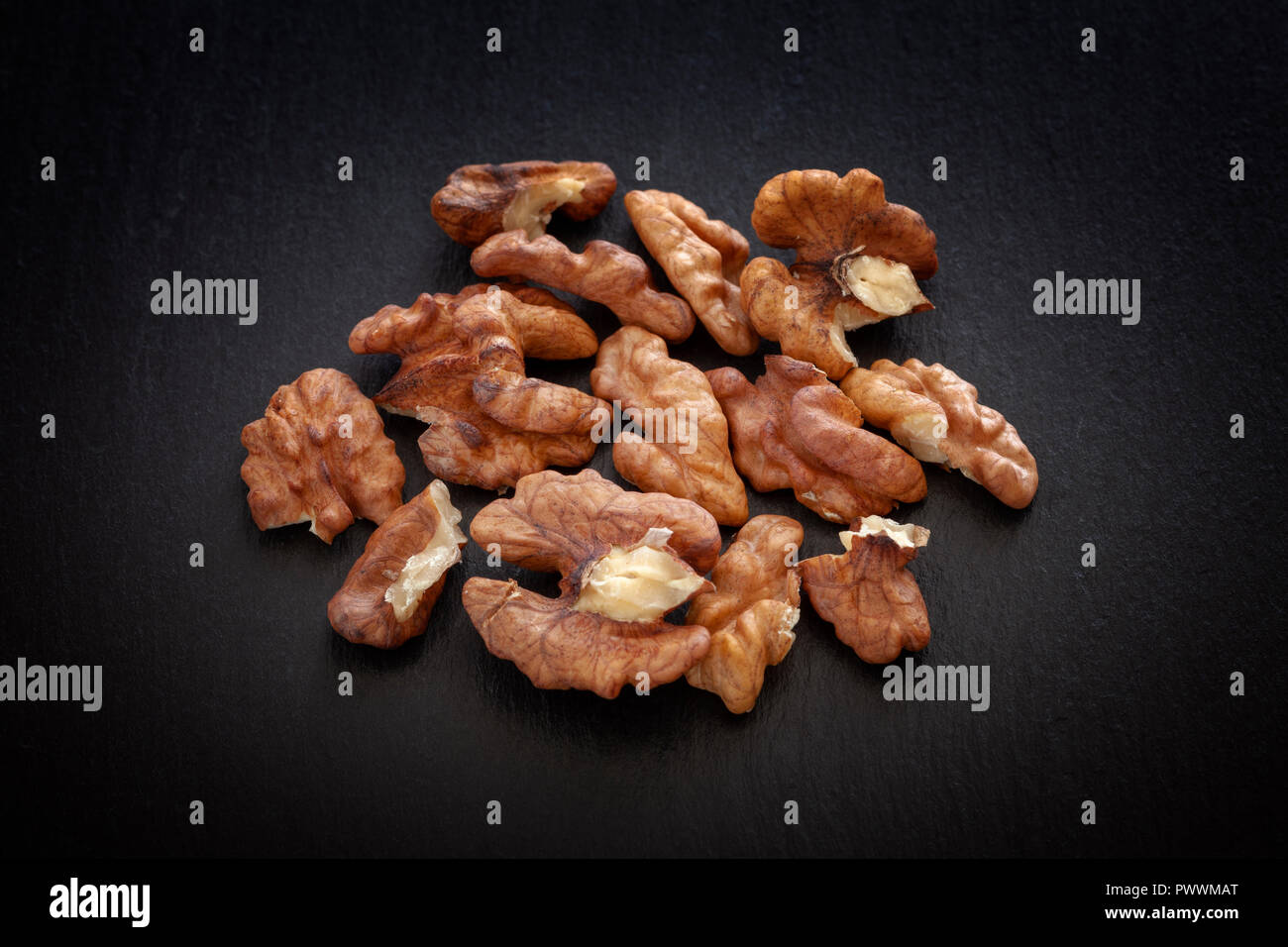 Walnuts on a black slate background. Close up. Stock Photo