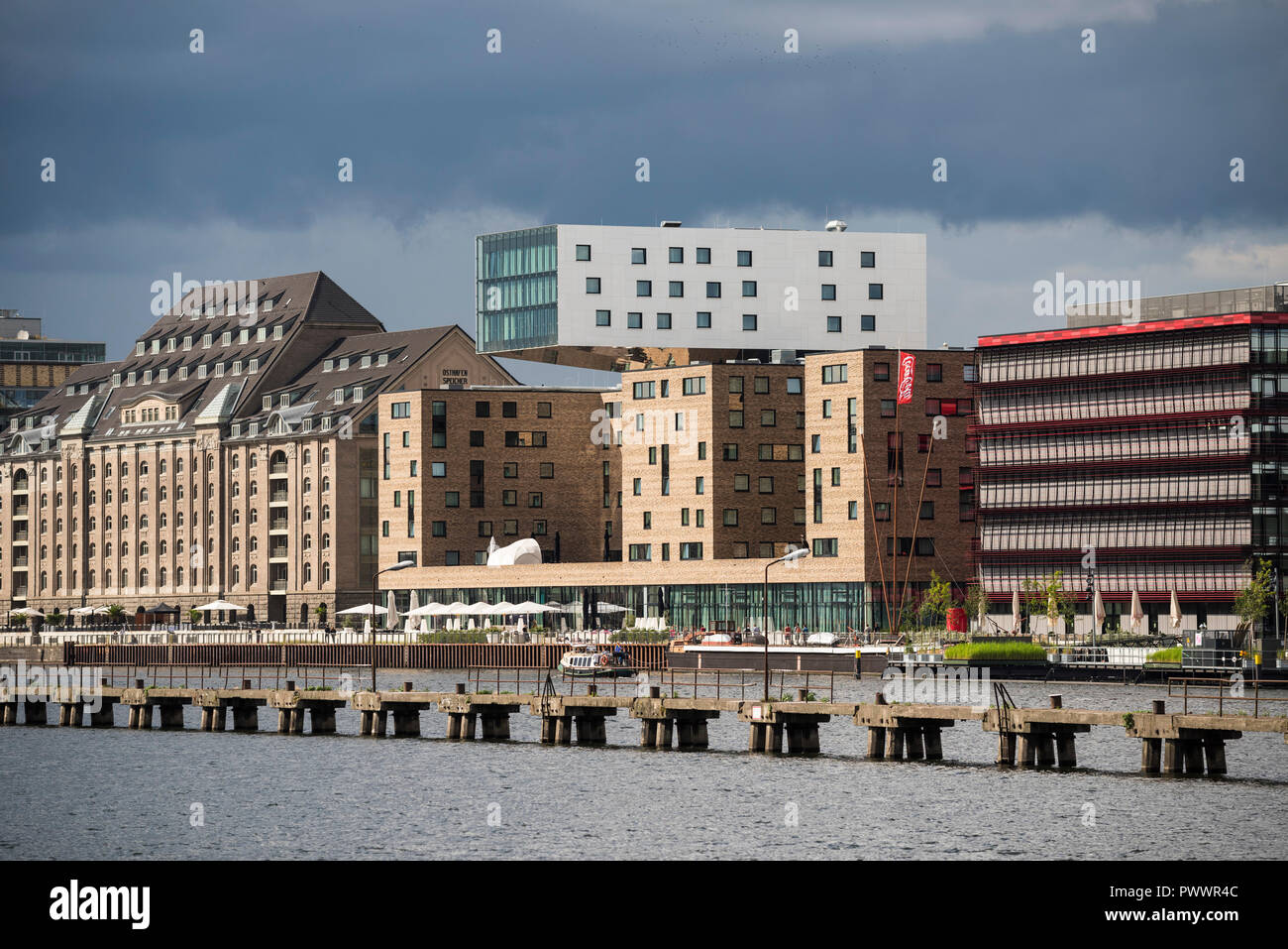 Berlin. Germany. Buildings on the redeveloped Osthafen (East Harbour) on the River Spree, Friedrichschain. L-R; Spreespeicher, Hotel Nhow, Coca Cola H Stock Photo