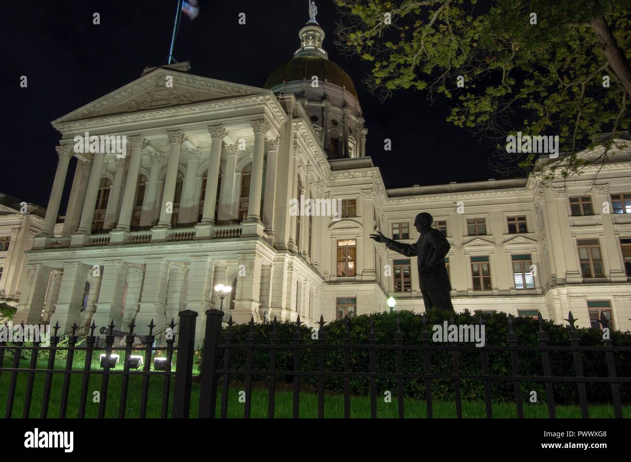 Atlanta, GA--Oct 17, 2018 bronze state of Ellis Arnall stands in front of the Georgia state house illuminated at night Stock Photo