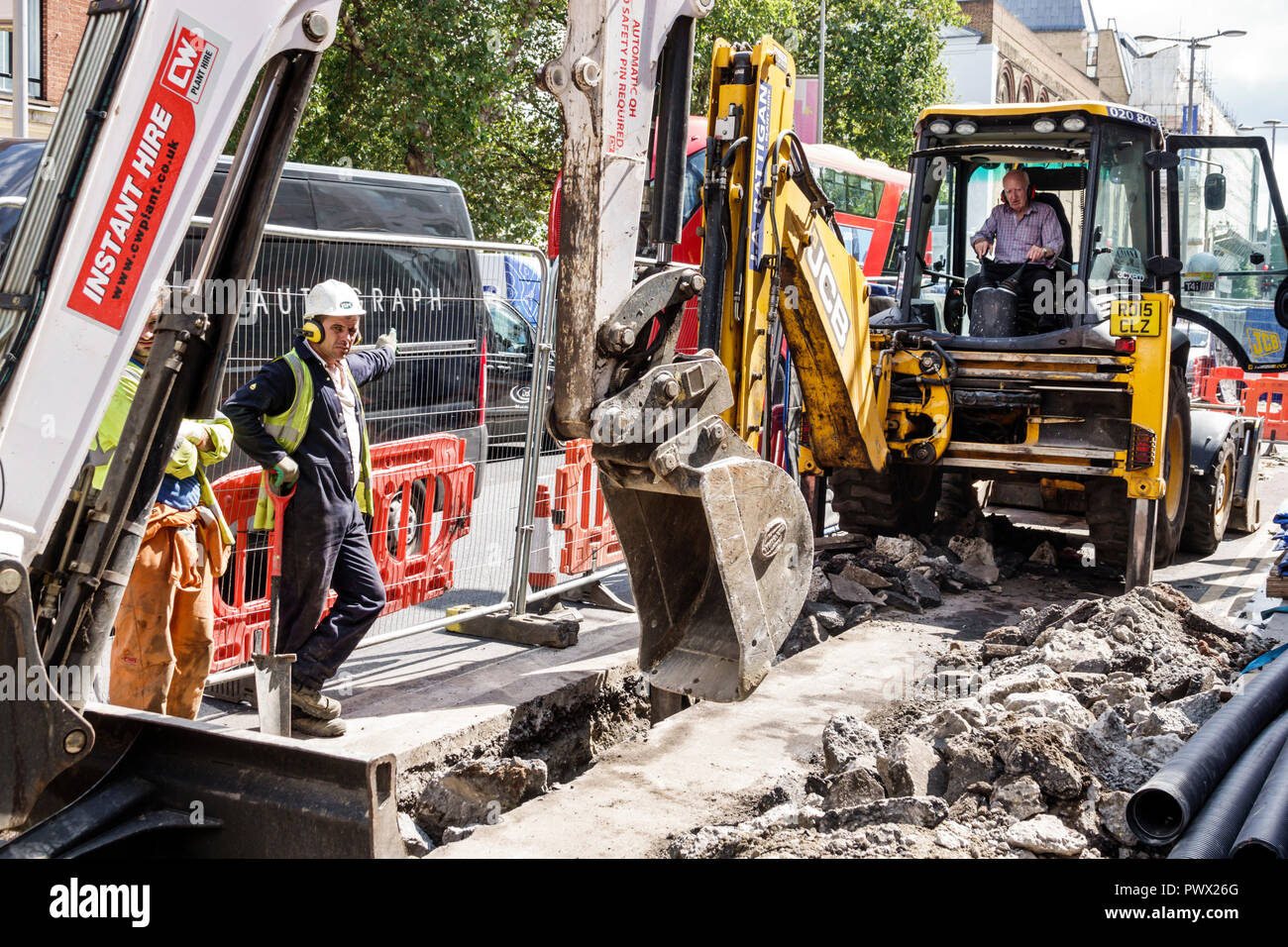 London England,UK,Lambeth South Bank,road pavement repair construction,public works infrastructure,digging,digger heavy equipment laborer,worker,hard Stock Photo