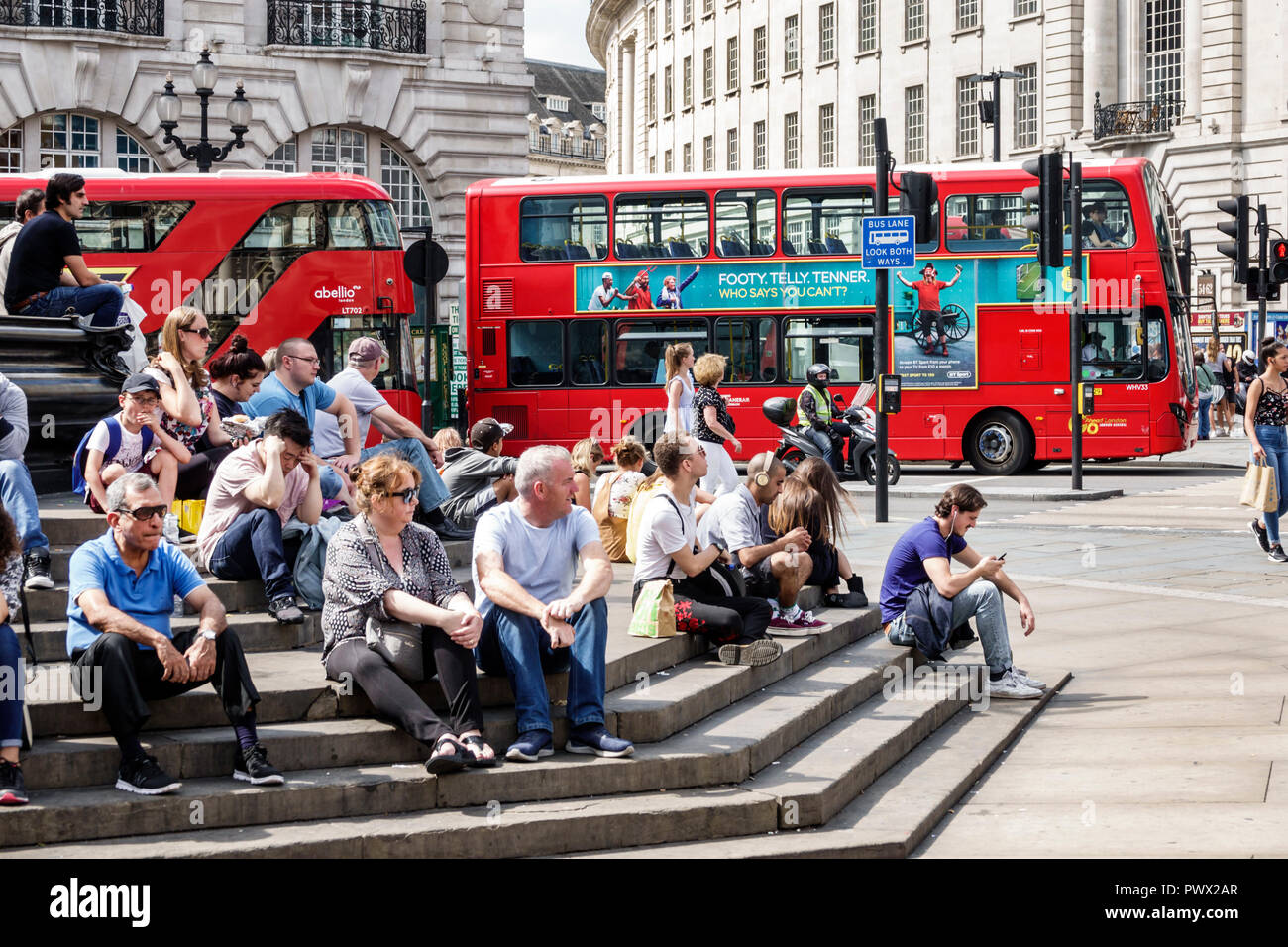 London England United Kingdom Great Britain West End Piccadilly Circus St Jamess Shaftesbury Memorial Fountain Steps Man Woman Boy Sitting Red Doubl London England United Kingdom Great Britain West End Piccadilly Circus St Jamess Shaftesbury Memorial Fountain Steps Man Woman Boy Sitting Red Doubl