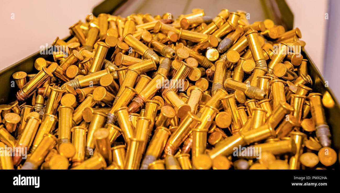 Metal box filled with cylindrical golden bullets Stock Photo Alamy