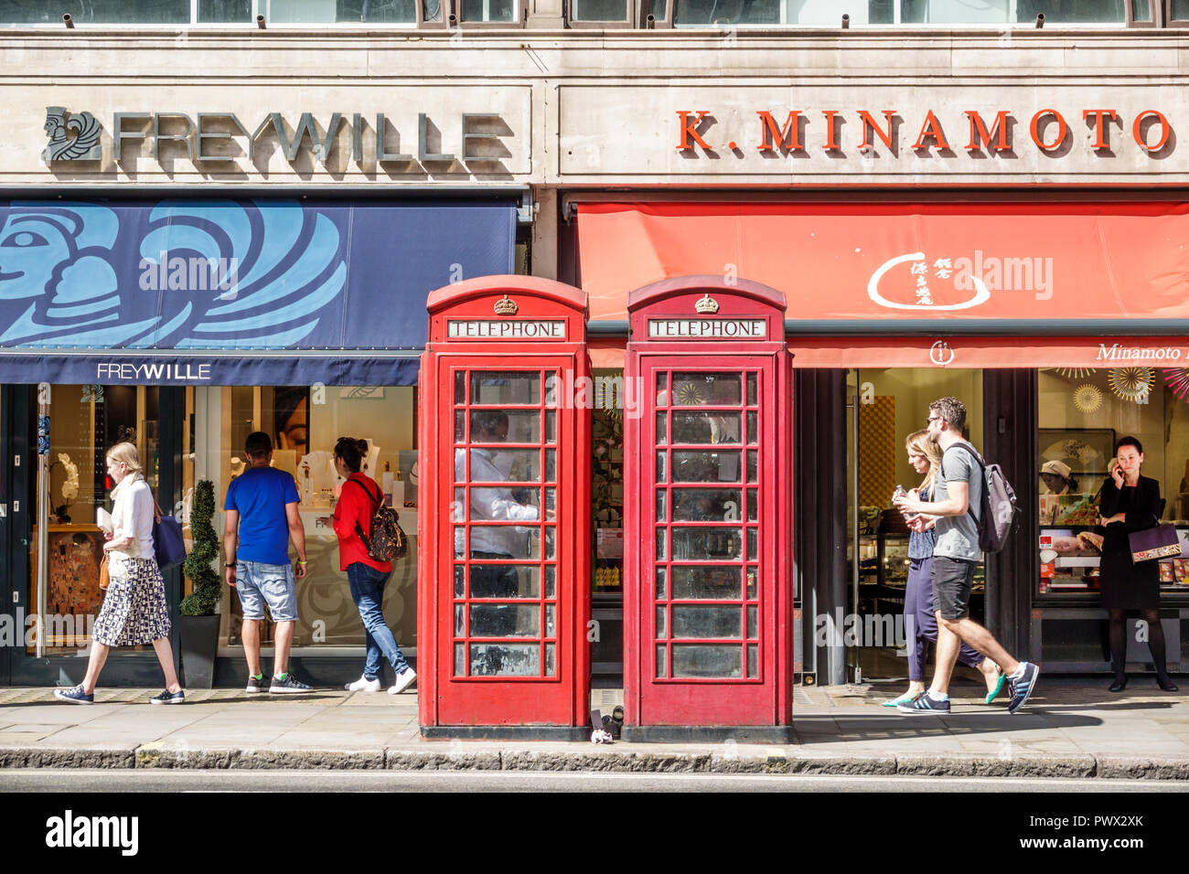 London England,UK,West End St James's,shopping district,storefronts,red telephone box,public phone booth kiosk,Giles Gilbert Scott,UK GB English Europ Stock Photo