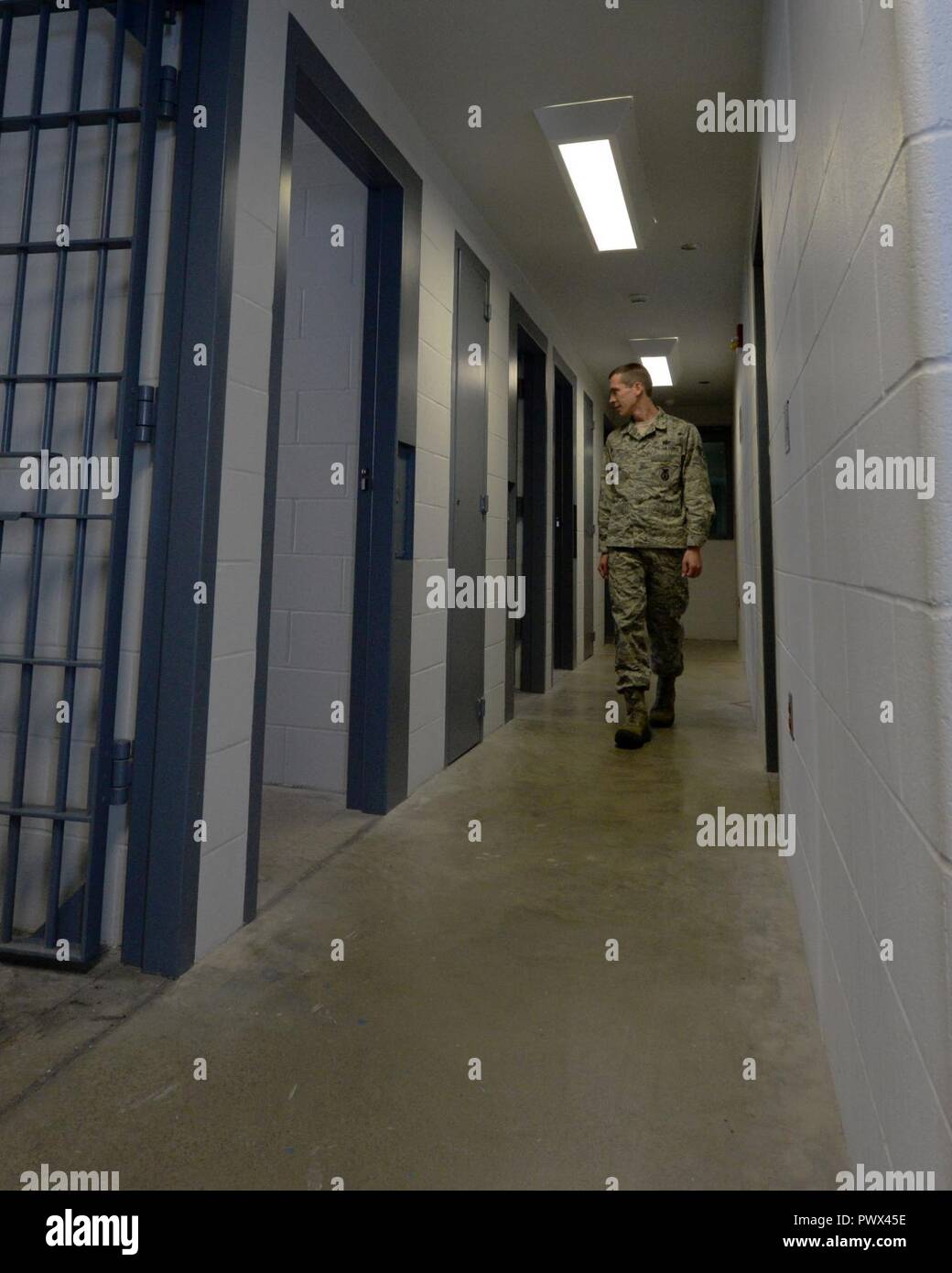 Staff Sgt. Justin Lamey, 88th Security Forces Squadron operations support non-commissioned officer, inspects the rooms inside the 88 SFS confinement facility at Wright-Patterson Air Force Base, Ohio, June 27, 2017. Inmates are housed up to one year, depending on the duration of their confinement period, or until ready for transfer to an alternate confinement. Stock Photo