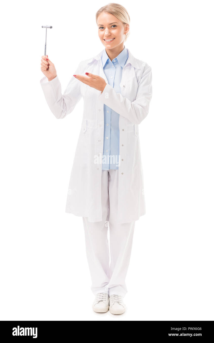 happy young female neurologist pointing at reflex hammer isolated on white Stock Photo