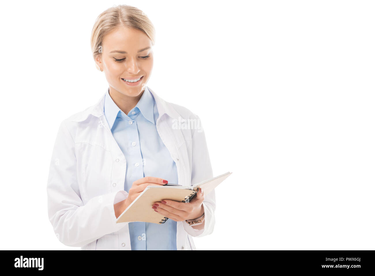 happy young female doctor writing in notebook isolated on white Stock ...