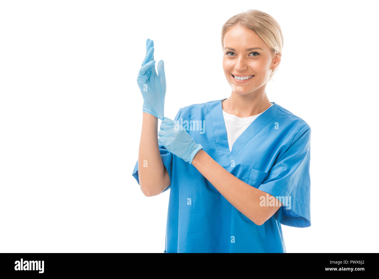 happy young nurse putting on rubber gloves isolated on white Stock ...