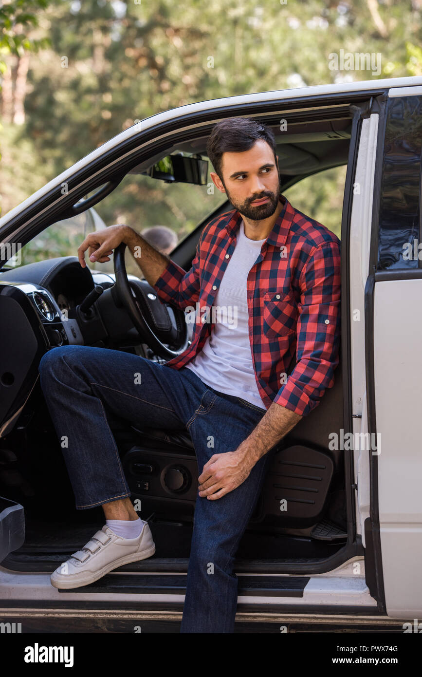 handsome bearded driver sitting in pickup truck in forest Stock Photo ...