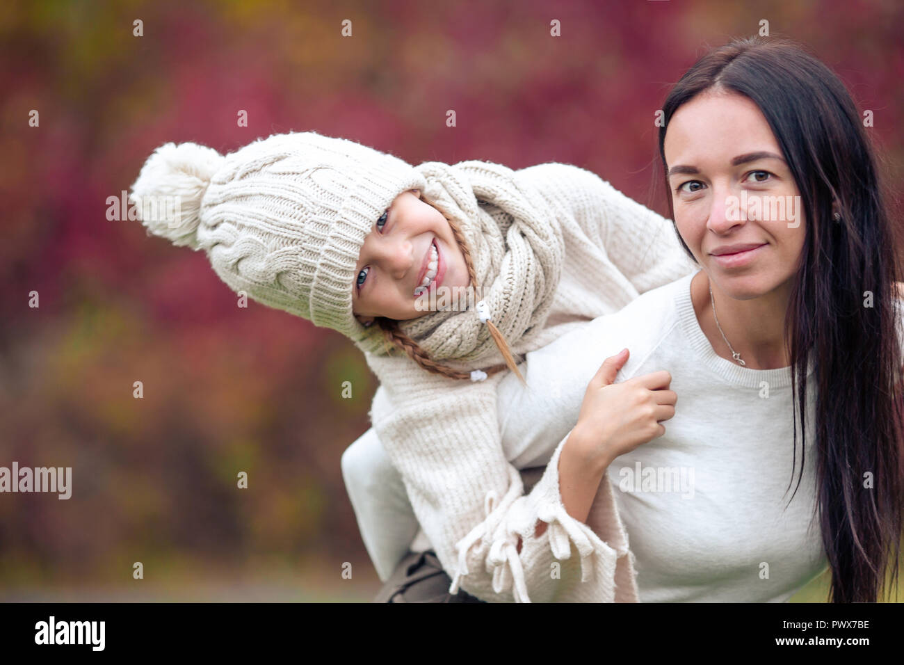 Little girl with mom outdoors in park at autumn day Stock Photo - Alamy