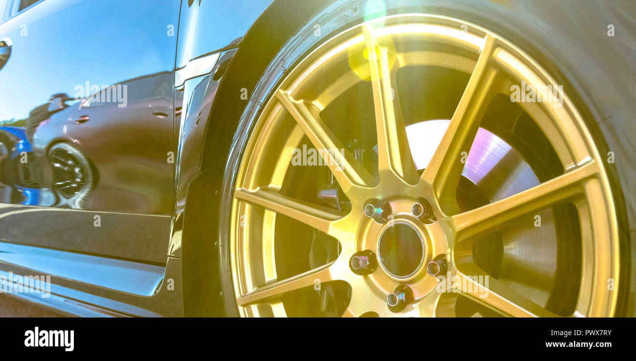 Tire rim with golden spokes of a reflective car Stock Photo Alamy