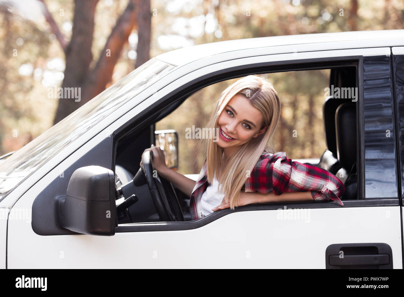 beautiful young driver sitting in pickup truck in forest Stock Photo ...