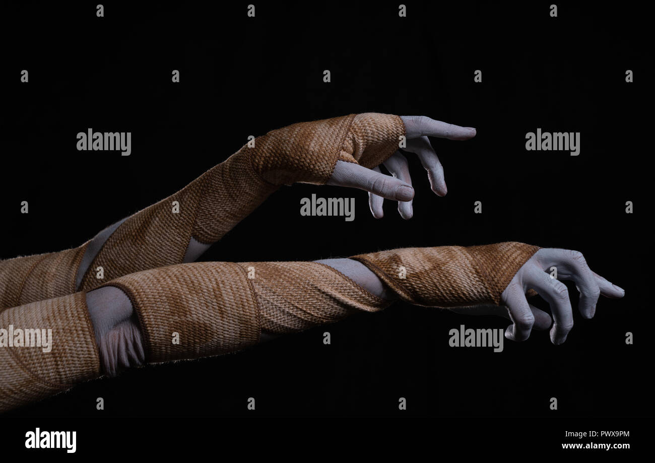 Creepy mummy stretching hands wrapped in bandages, Halloween theme Stock Photo