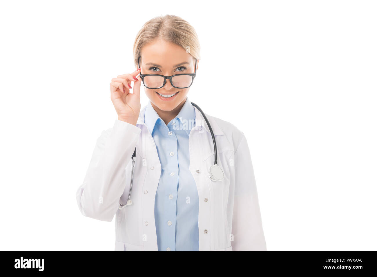smiling young female doctor looking at camera over eyeglasses isolated ...