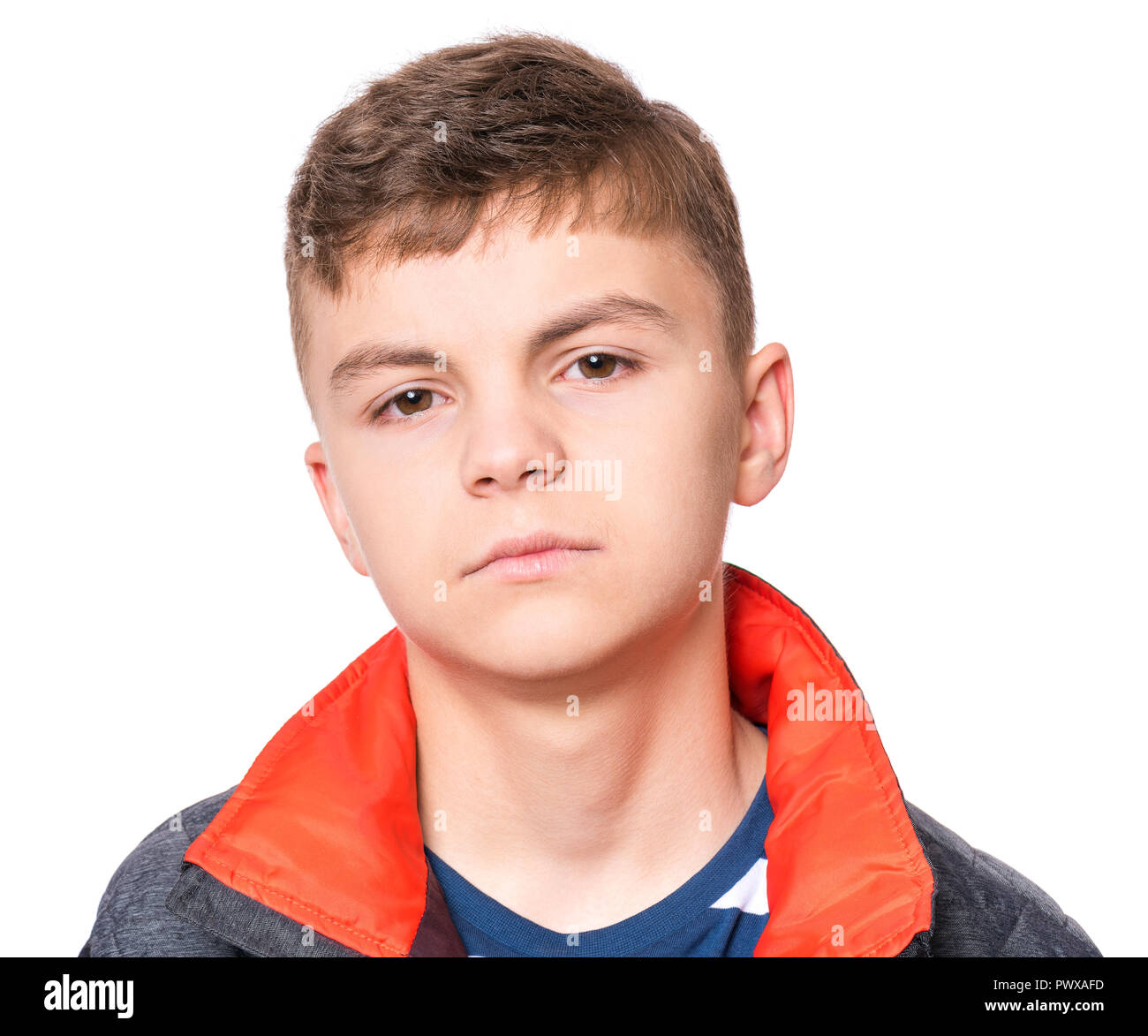 Emotional portrait of caucasian teen boy. Serious, sad or thoughtful handsome young teenager - close up. Studio head shot - isolated on white backgrou Stock Photo