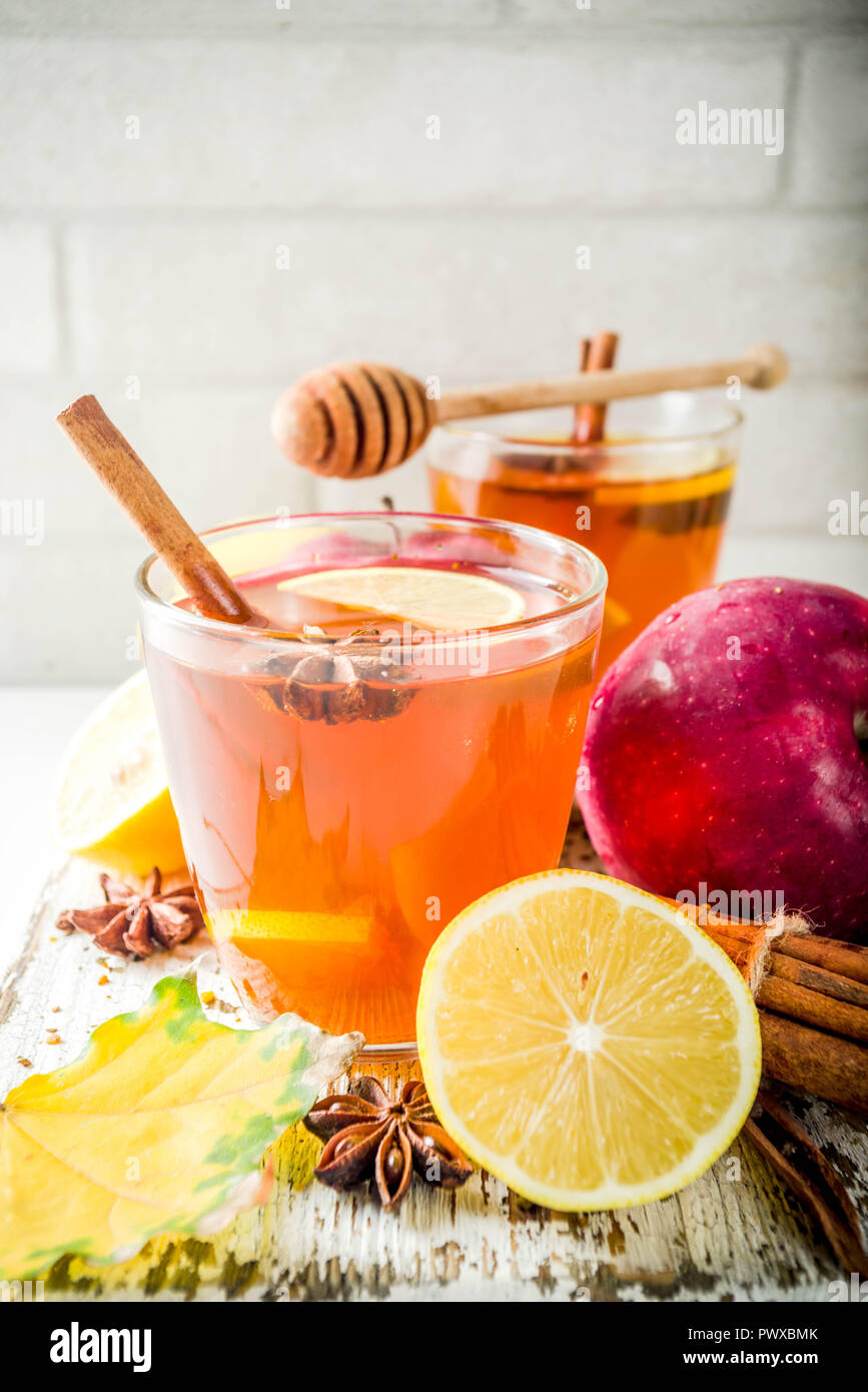 Red Fall Tea Two cups of autumn winter hot spicy tea with red apples, lemons ...