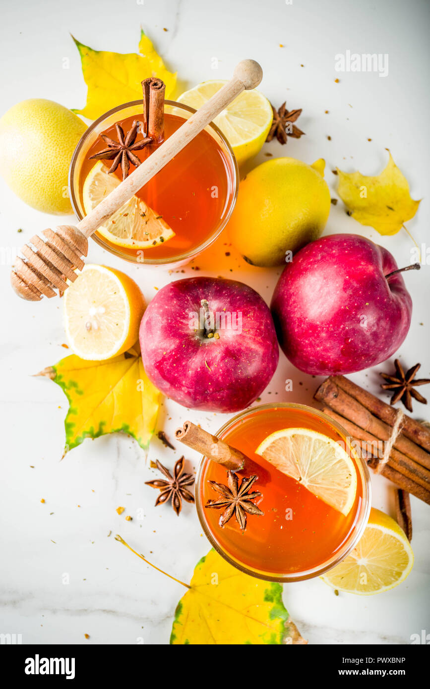 Red Fall Tea Two cups of autumn winter hot spicy tea with red apples, lemons ...