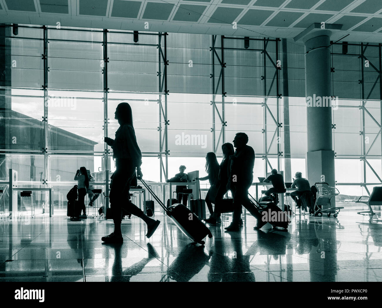 People using mobile devices and laptops in Wifi zone at Barcelona El Prat airport. Spain Stock Photo