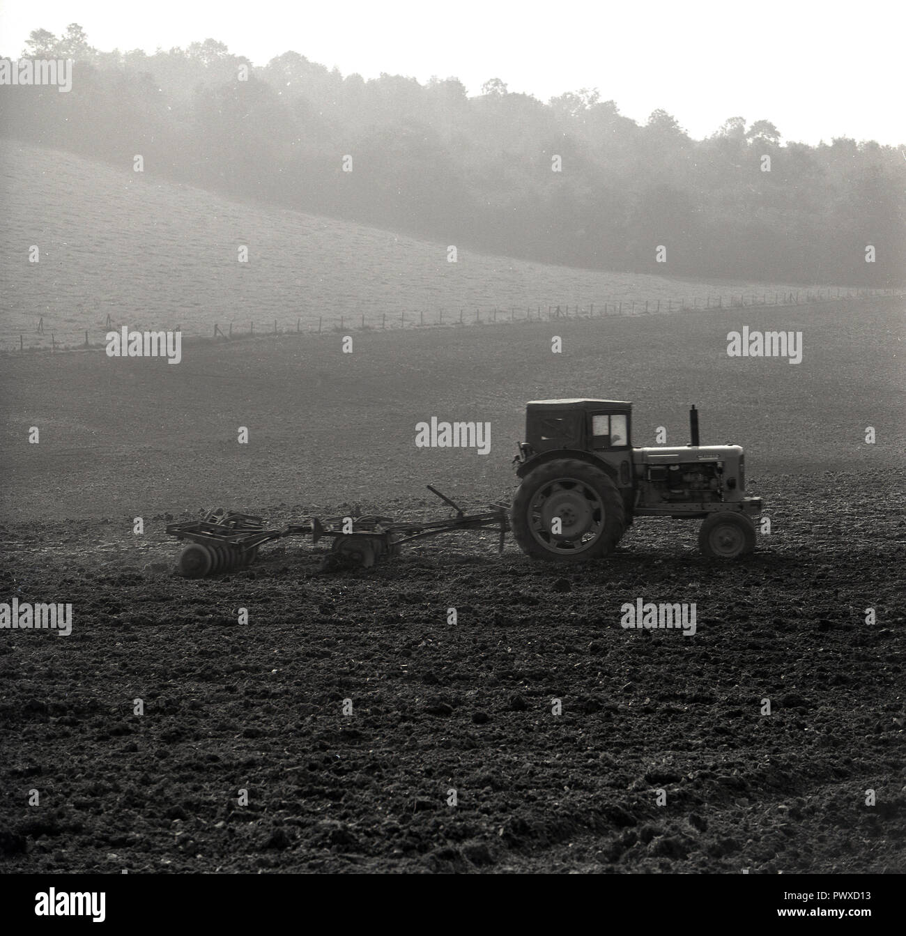 1950s, historical, farming, ploughing, a tractor in a field pulling