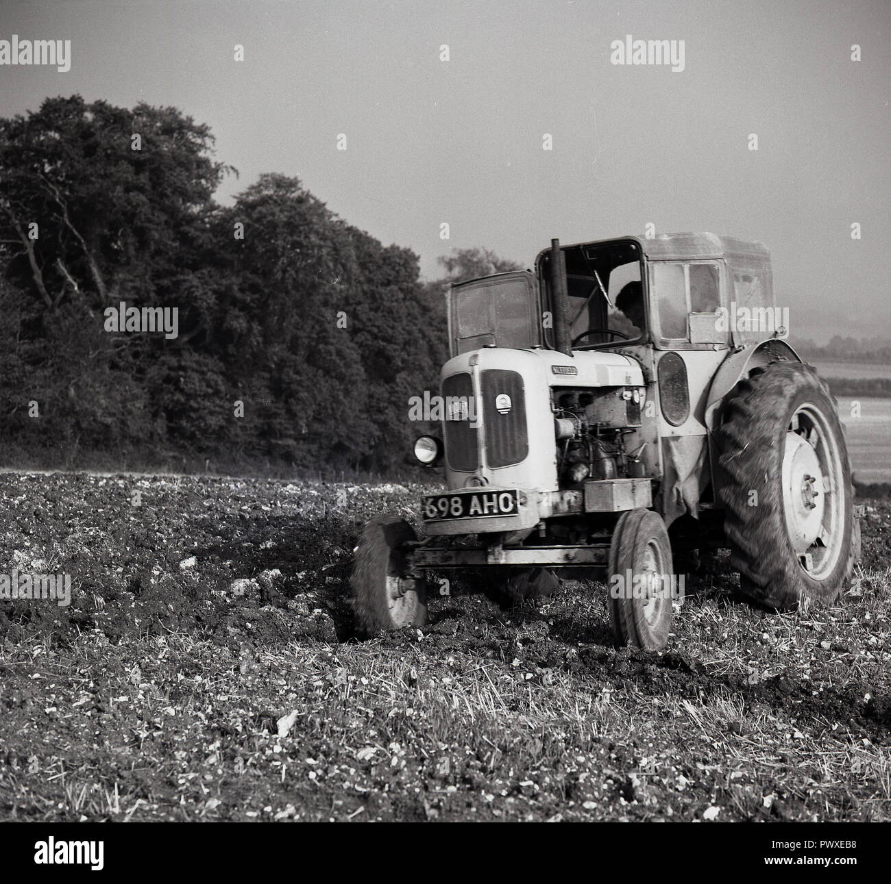 1950s, farming, tractor of the era in an open field, England, UK. Stock Photo