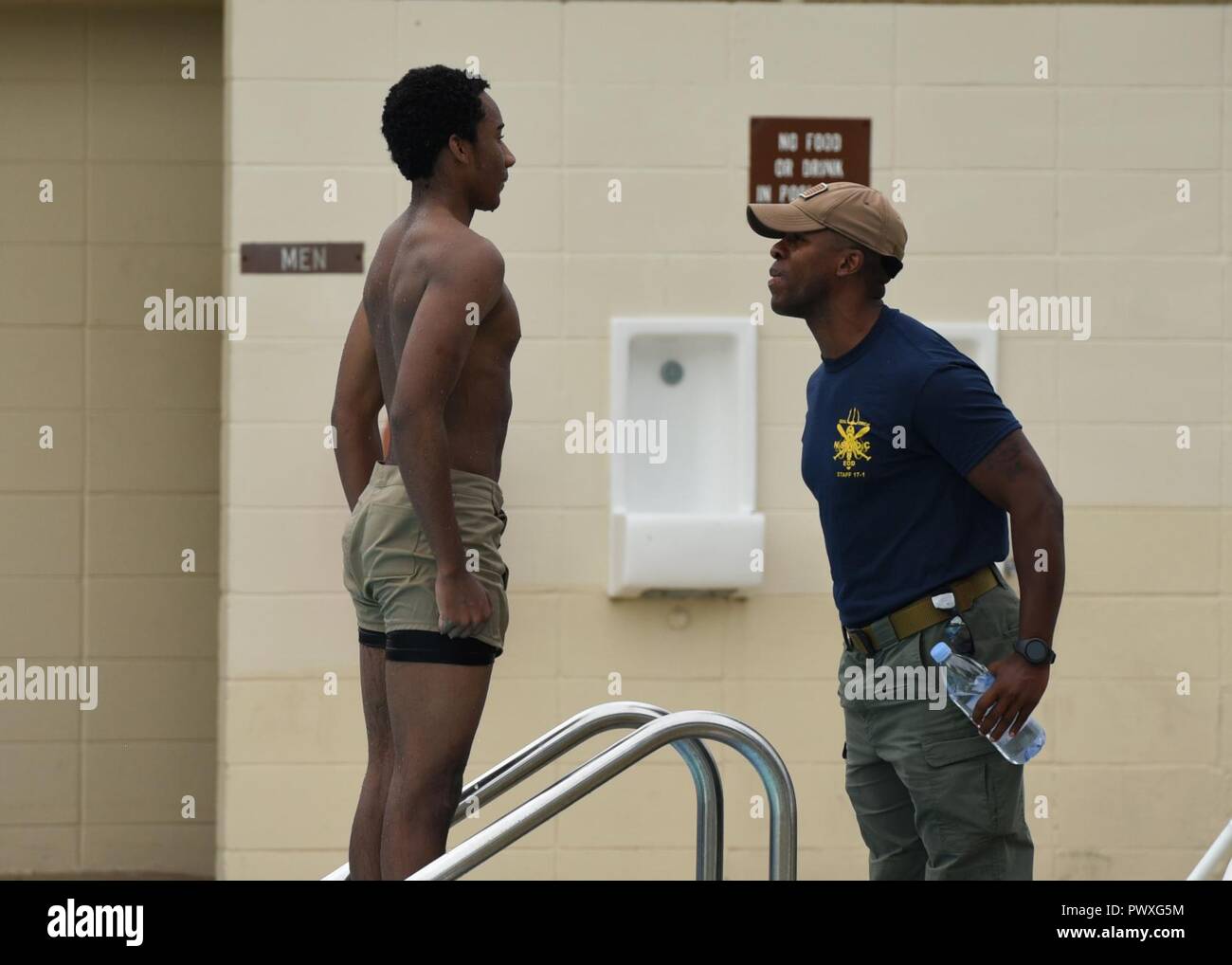 Cadet Hayes, a U.S. Naval Sea Cadet Corps cadet, is praised by an instructor moments after the swimming portion of a physical readiness test at Tyndall Air Force Base, Fla., June 26, 2017. Hayes passed the timed 500 meter swimming portion of the physical readiness test the day after previously failing. Stock Photo