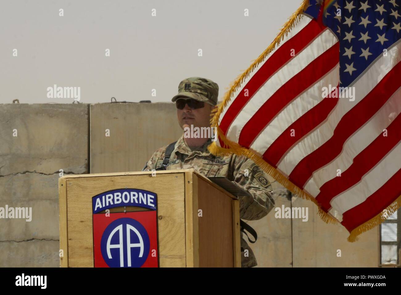 U.S. Army Capt. Scott Rayburn, commander of Alpha Company, 37th Engineer Battalion, 2nd Brigade Combat Team, 82nd Airborne Division, addresses those in attendance, especially his sister, U.S. Army Capt. Kaitlin Whitmore, commander of Charlie Company, 215th Brigade Support Battalion, 3rd Armored Brigade Combat Team, 1st Cavalry Division, during his first-ever change-of-command ceremony at Qayyarah West Airfield, Iraq, July 1, 2017. Stock Photo