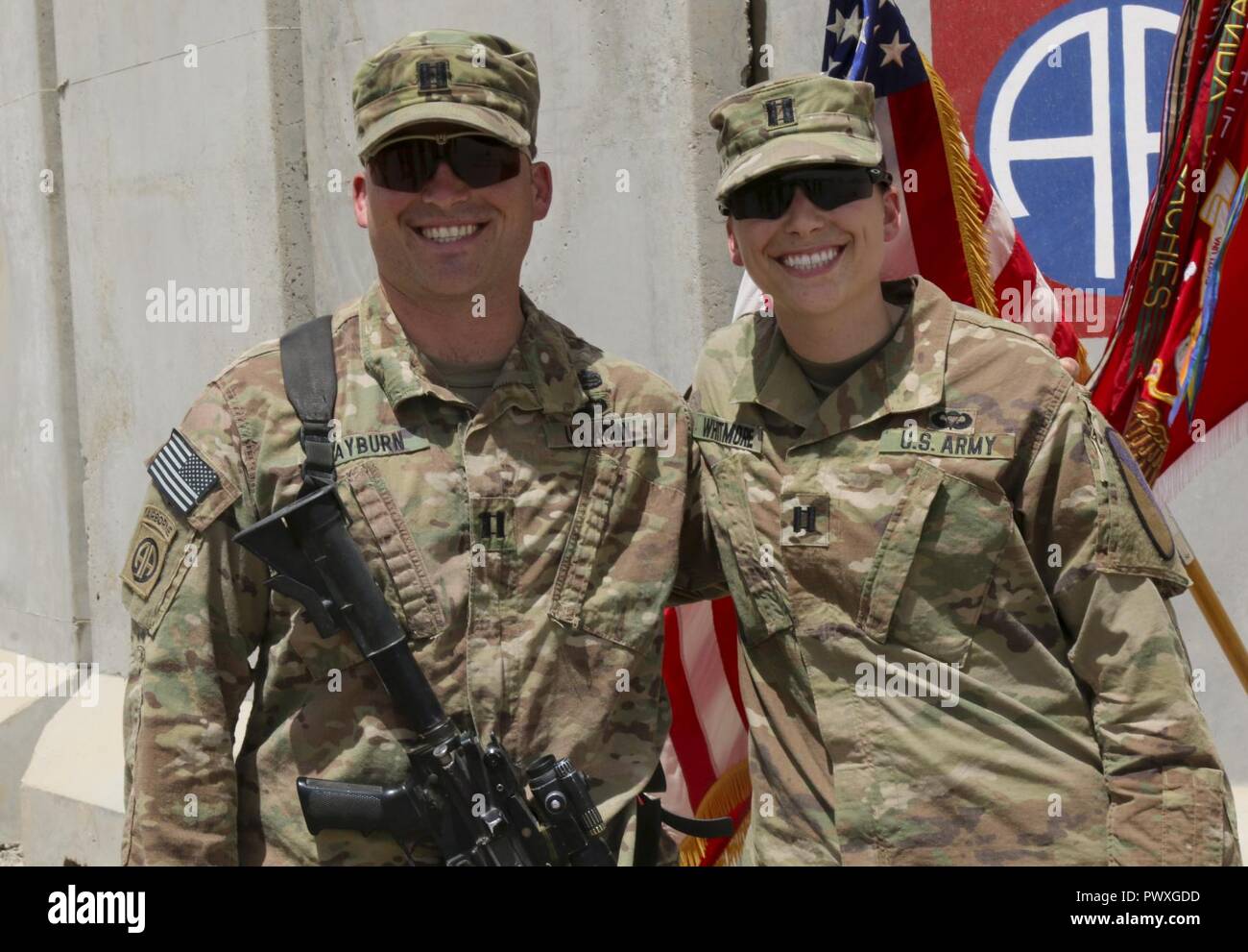 U.S. Army Capt. Kaitlin Whitmore, commander of Charlie Company, 215th Brigade Support Battalion, 3rd Armored Brigade Combat Team, 1st Cavalry Division, and her brother, U.S. Army Capt. Scott Rayburn, incoming commander of Alpha Company, 37th Engineer Battalion, 2nd Brigade Combat Team, 82nd Airborne Division, were able to see each other briefly when she attended his first change-of-command ceremony in Qayyarah West Airfield, Iraq, July 1, 2017. The siblings, who hail from Gainesville, Florida, both attended ROTC in college and were even commissioned during the same week in 2011. Stock Photo