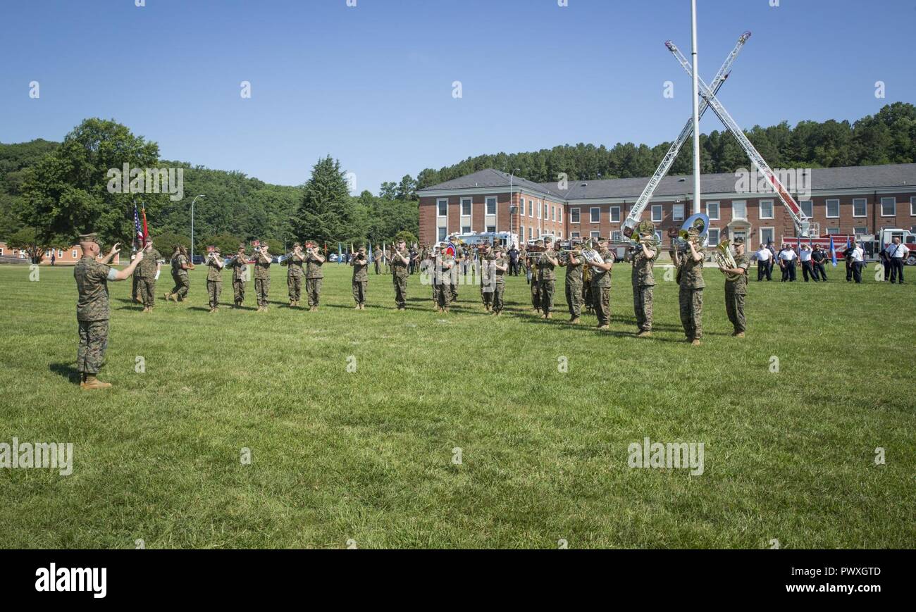 U.S. Marines with the Quantico Marine Band perform during a change of command ceremony held at Lejeune Field, Marine Corps Base Quantico, June 21, 2017. The ceremony was held to transition command from Lt. Col. Robert E. Cato II, outgoing commanding officer for Security Battalion to Lt. Col. Mark T. Shnakenberg, incoming commanding officer. Stock Photo