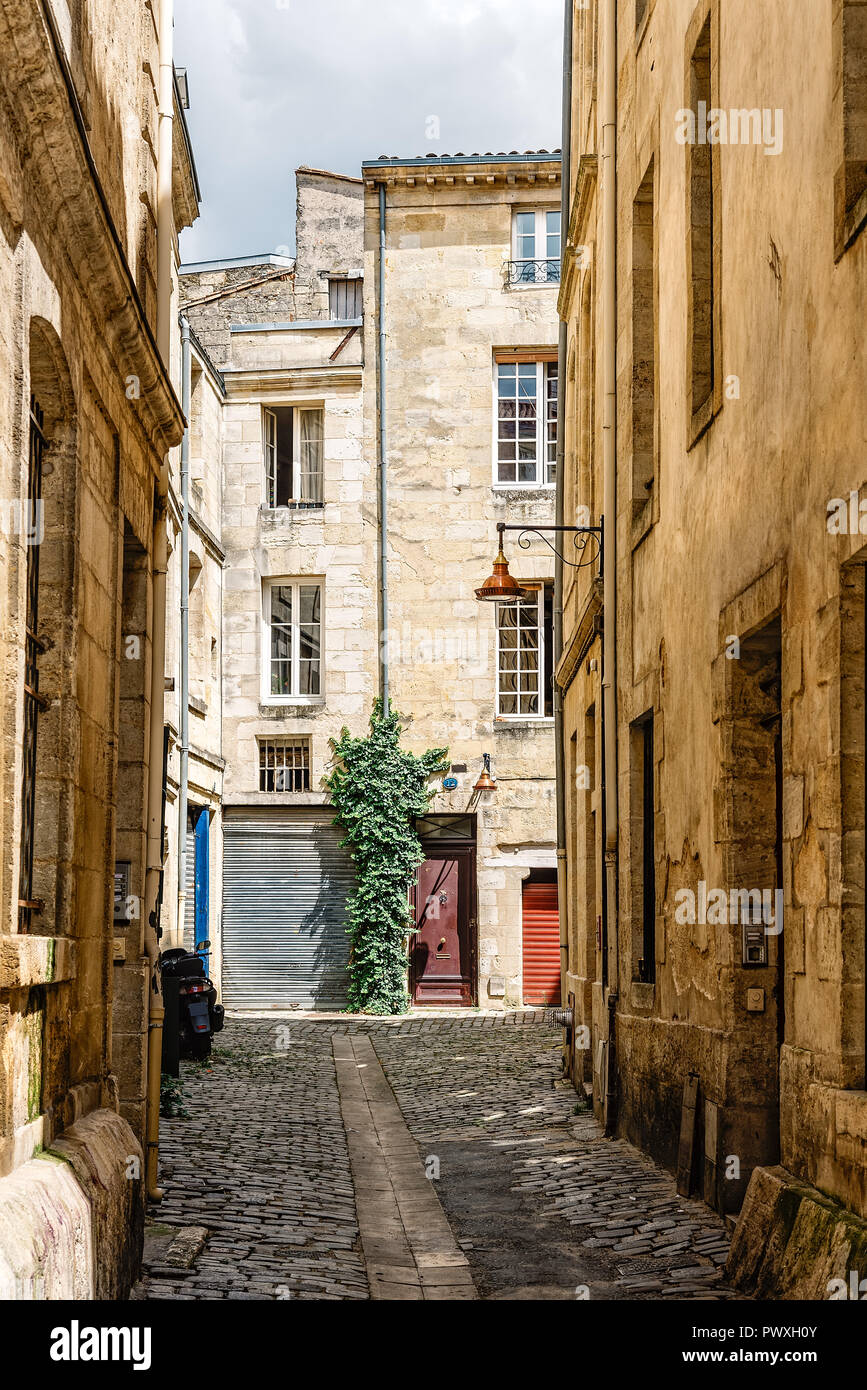 Narrow cobblestoned street in historic city centre of Bordeaux, France Stock Photo