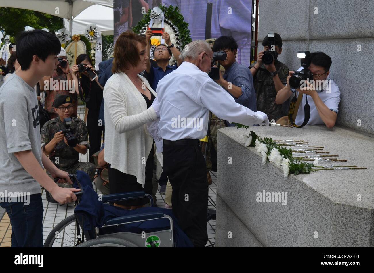 Task force smith s war veteran places one flower on the memorial at the