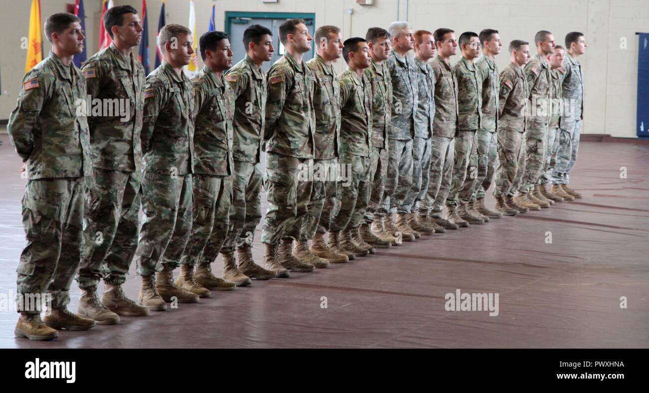 Soldiers of the 101st Airborne Division (Air Assault), stand in formation awaiting to receive the Expert Field Medical Badge, during the EFMB graduation ceremony June 22, Fort Campbell, Kentucky. Out of 107 candidates that started the EFMB testing, only 18 were honored to receive the coveted EFMB. Stock Photo