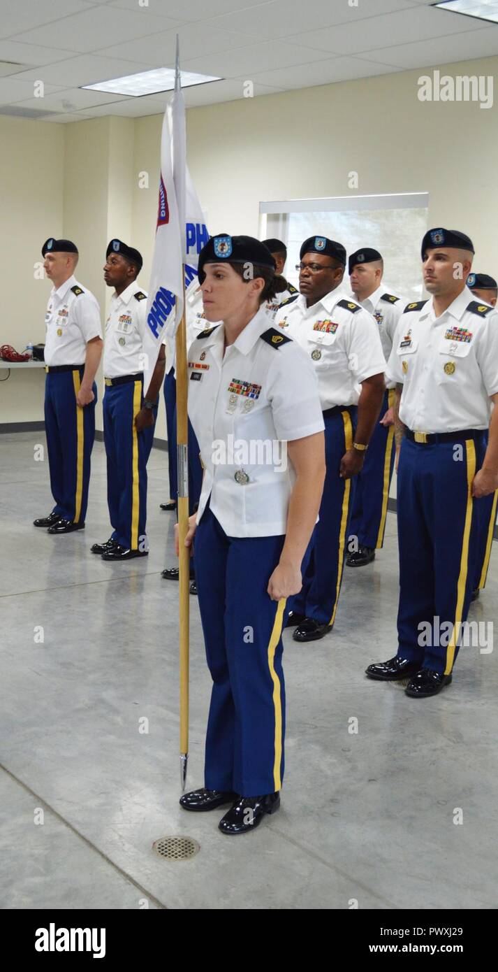 Staff Sgt. Jennifer Kirim, center leader, Black Canyon Recruiting Center, holds the Phoenix North Recruiting Company guidon, during a change of command ceremony, June 30, West Maricopa Education Center, Phoenix. Stock Photo