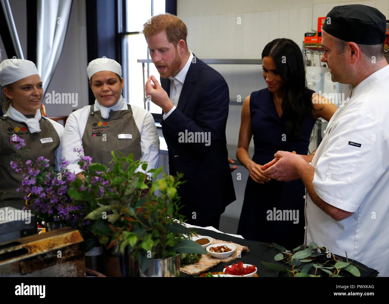 The Duke and Duchess of Sussex look at traditional native Australian ingredients during a visit to Mission Australia social enterprise restaurant Charcoal Lane in Melbourne, on the third day of the royal couple's visit to Australia. Stock Photo