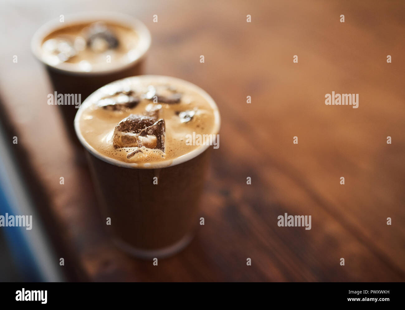 Two takeaway ice coffees sitting on a cafe counter Stock Photo Alamy
