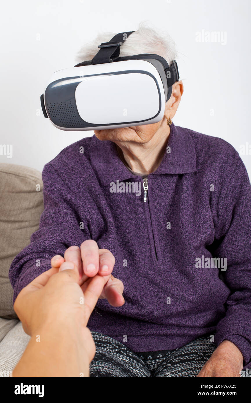 Elderly women experiencing virtual reality video with headset Stock Photo