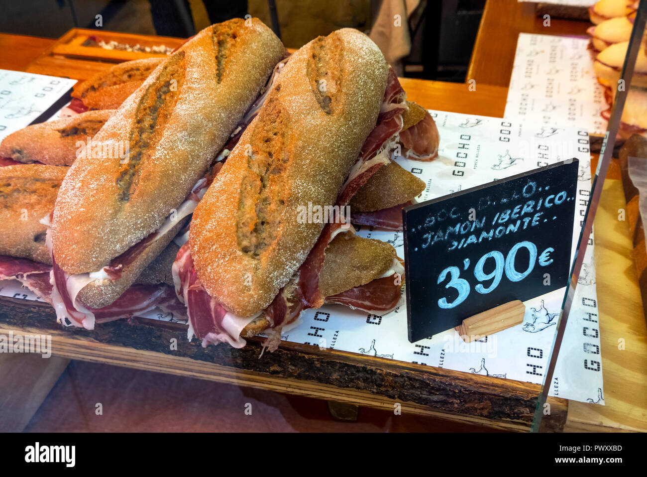 Two large sandwiches on crusty bread with Acorn-fed Iberian Ham (Serrano Ham) selling for 3,90 euros in the window of a Seville cafe Stock Photo