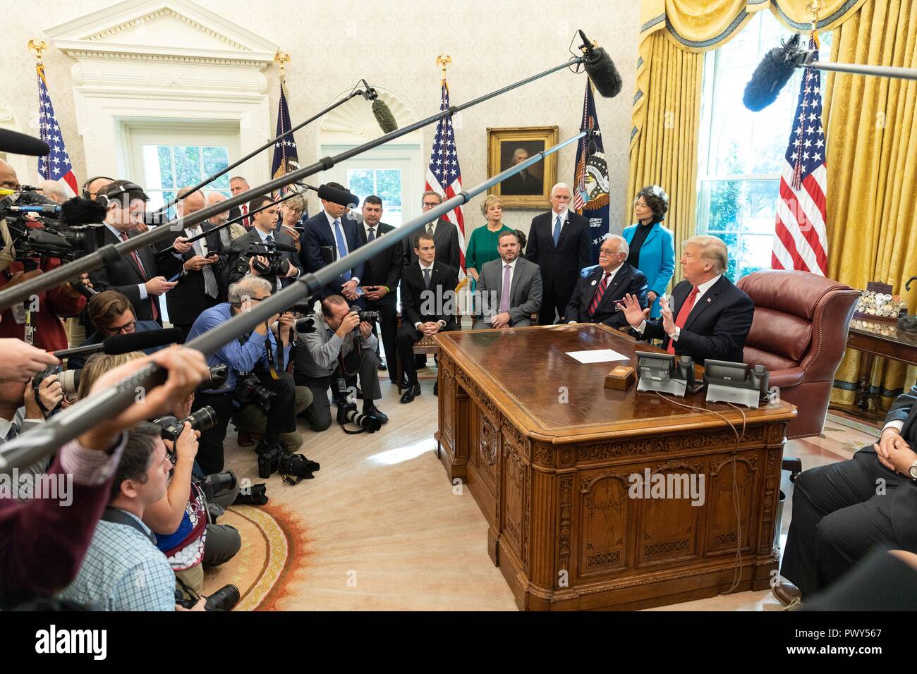 U.S President Donald Trump, joined by Vice President Mike Pence and members of his Cabinet holds an impromptu press conference after the “Cutting the Red Tape and Unleashing Economic Freedom” event in the Oval Office of the White House October 17, 2018 in Washington, DC. Stock Photo