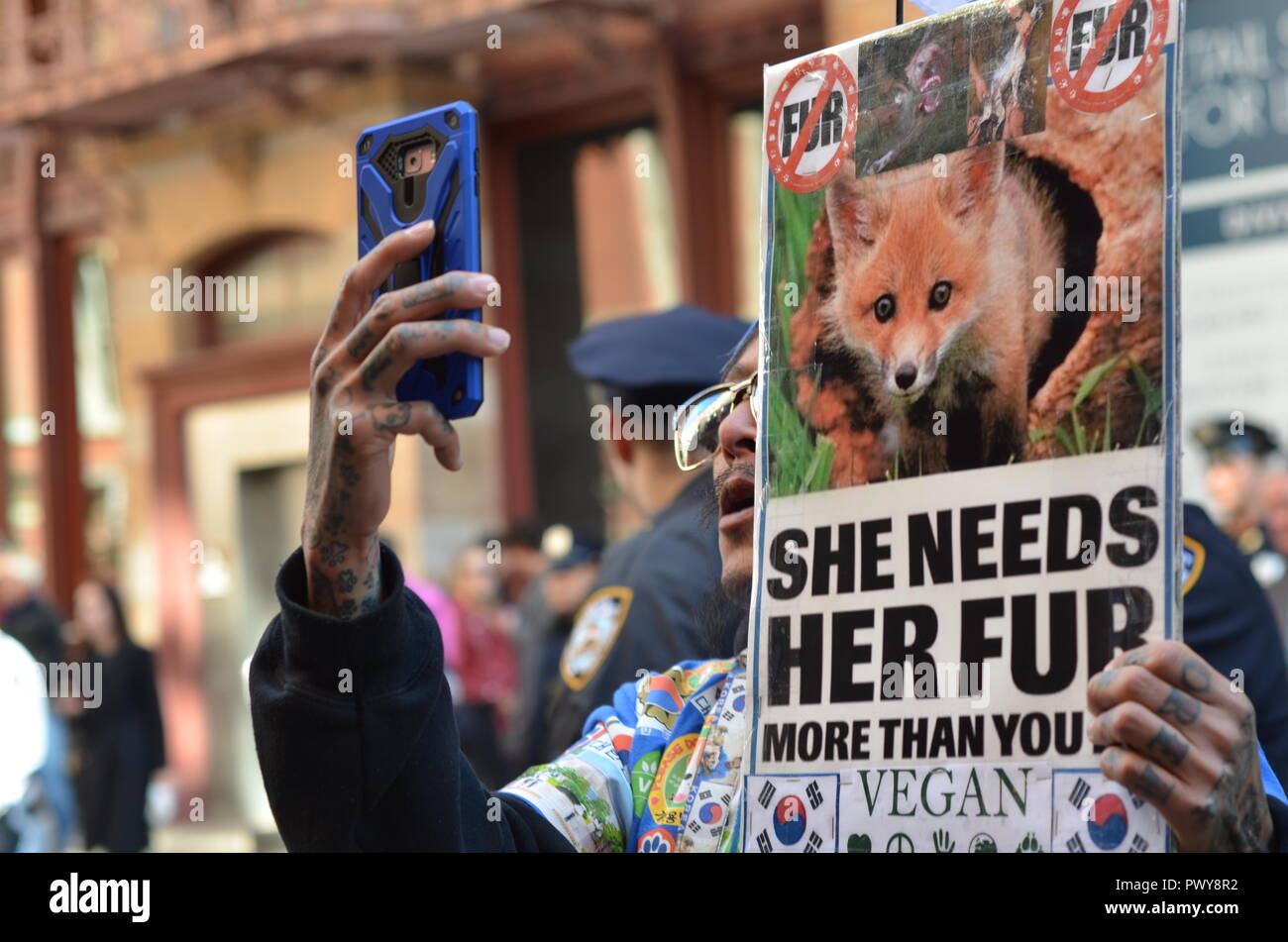 New York, USA. 18th October, 2018. Today animal-rights protesters showed up outside the new Canada Goose store in Soho, New York City. As temperatures drop, and New Yorkers start shopping for winter coats, People for the Ethical Treatment of Animals ( PETA) organized this protest. Protesters believe The Canada Goose winter jackets comes from wild coyotes who were trapped, killed, and skinned. Credit: Ryan Rahman/Alamy Live News Stock Photo