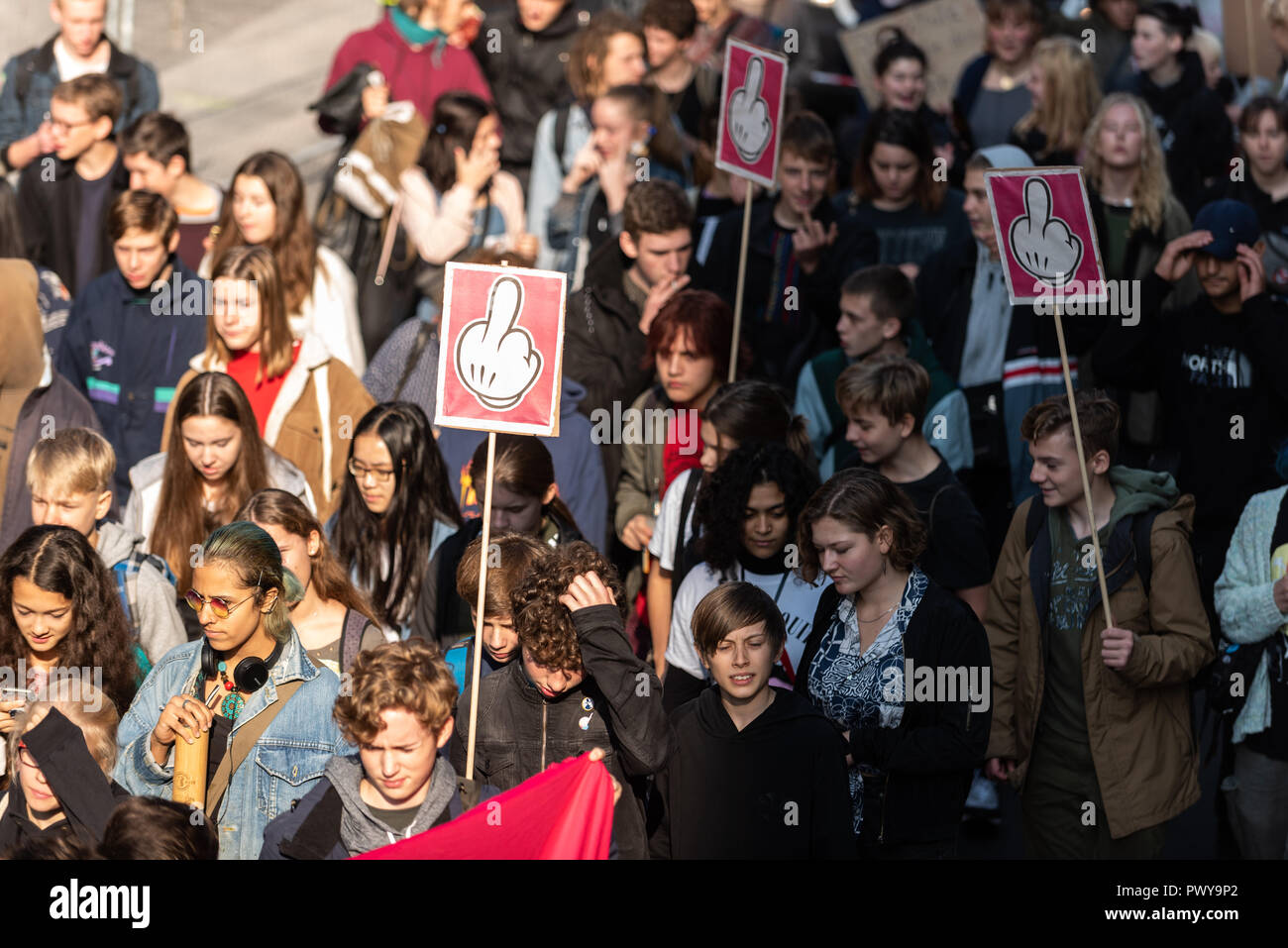 Protesters are seen holding placards with an outstretched middle finger during the school strike Hundreds of students demonstrate during the school strike for a fair and self-designed education system. Stock Photo