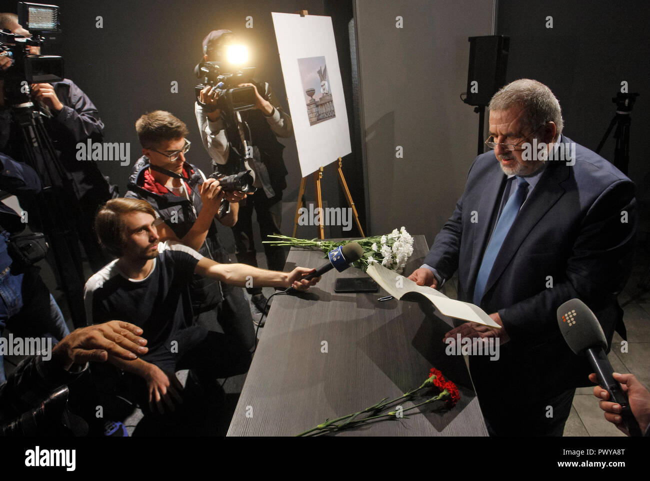 Refat Chubarov, leader of the Crimean Tatar national movement in Ukraine and worldwide is seen speaking with media after signing a condolence book as a sign of mourning to the victims of the attack during the commemoration. Commemorating the victims of an 18-year-old student who strode into his vocational college in Kerch in the Crimea, then pulled out a shotgun and opened fire, killing about 20 students and teachers and wounding about 74 others before killing himself, according the media. Stock Photo