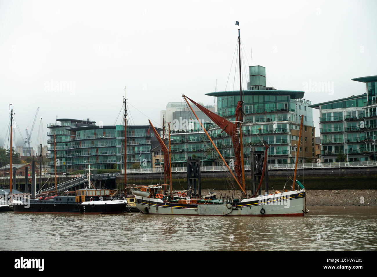 The Old Thames Barge Will Moored at The Hermitage Community Moorings on River Thames with Luxury Riverside Apartments London England UK Stock Photo
