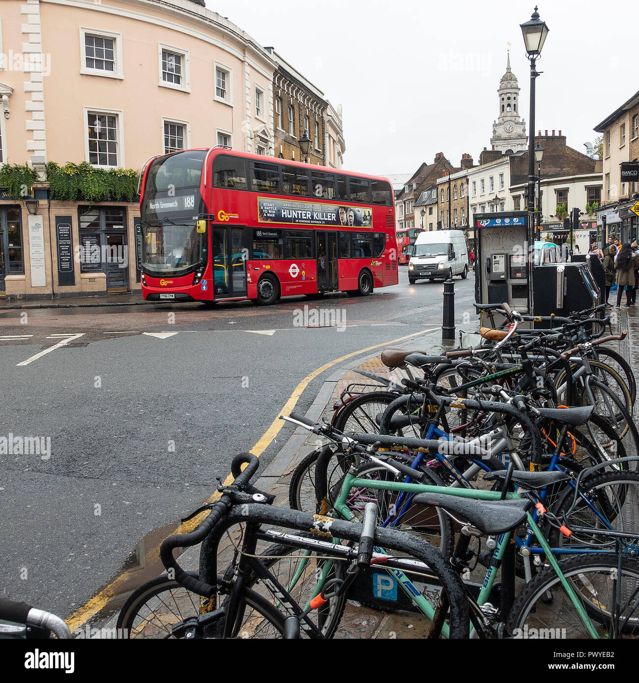 Bicycles Parked in a Rack with a Red London Transport Double Decker Bus in Greenwich Town Centre London England United Kingdom UK Stock Photo